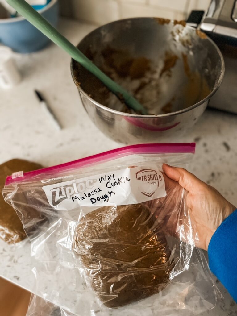 The tightly packed Make Ahead Chewy Molasses Cookies dough being wrapped for freezing