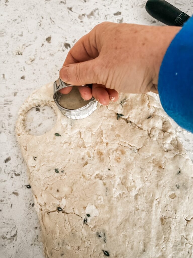 Marie cutting out biscuits from the dough