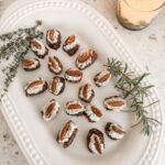 The platter of finished Stuffed Dates with Cheese and Herbs