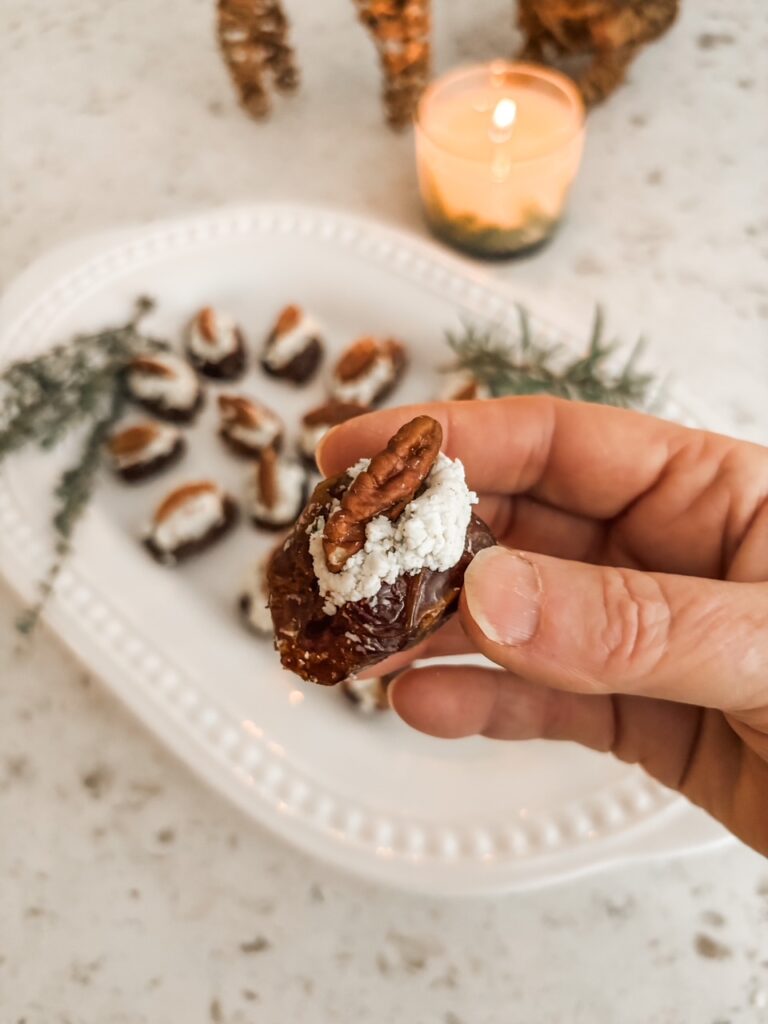 Marie holding up one of the Stuffed Dates with Cheese and Herbs