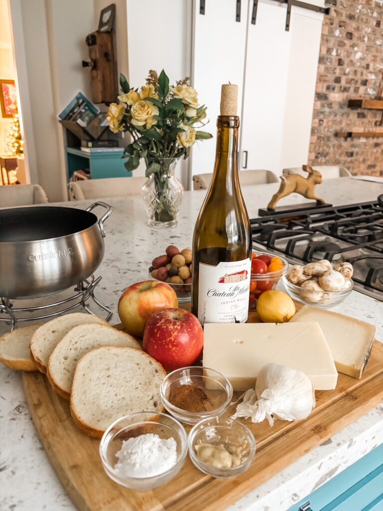 The ingredients and equipment for the fondue laid out on a table