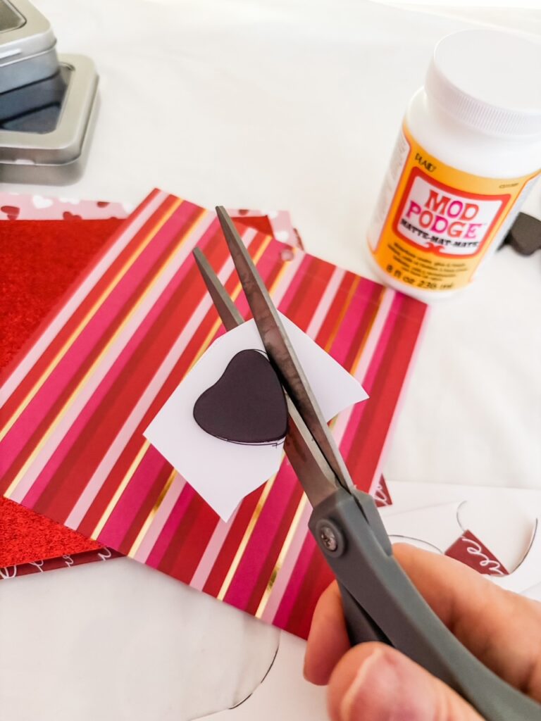 Cutting the heart shaped fabric around the magnet