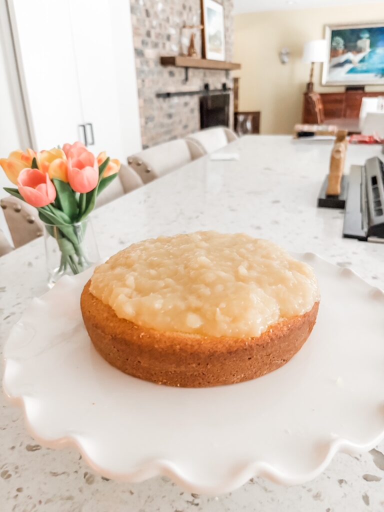 The first cake layer topped with the pineapple filling