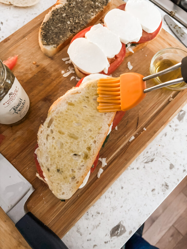 Brushing the oil on the bread prior to grilling