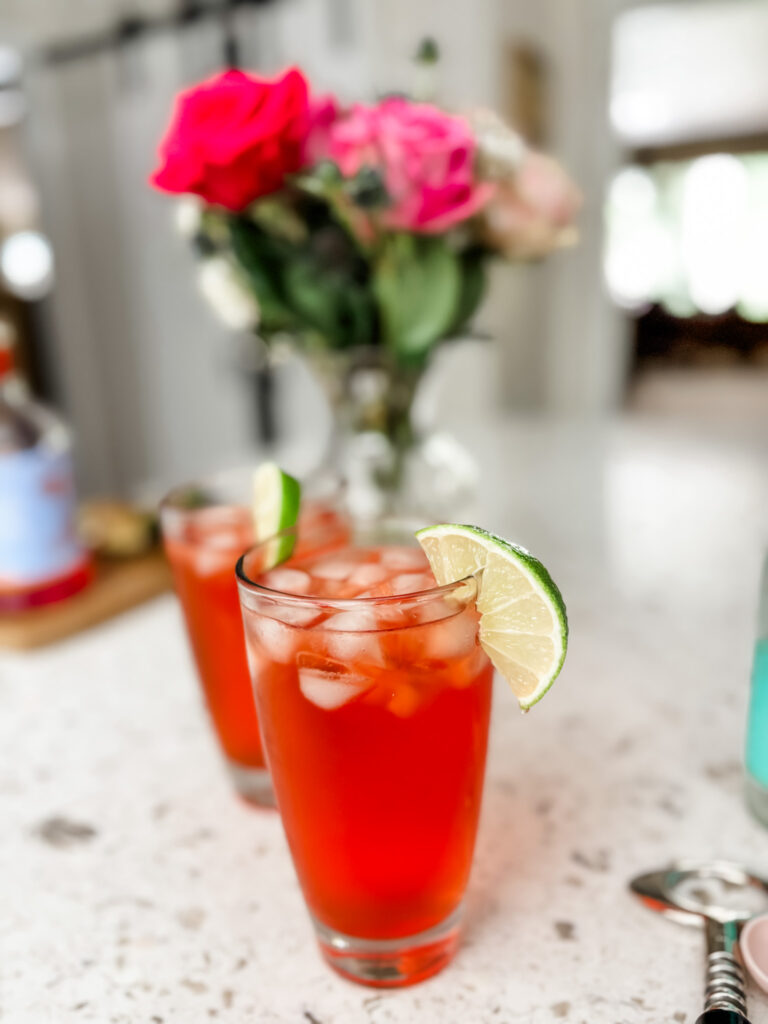 Two of the finished Italian Spritz mocktail garnished with a lime slice