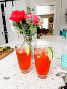 Two of the finished Italian Spritz mocktail garnished with a lime slice