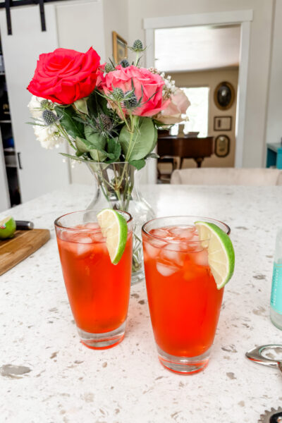 Two of the finished Italian Spritz mocktail garnished with a lime slice