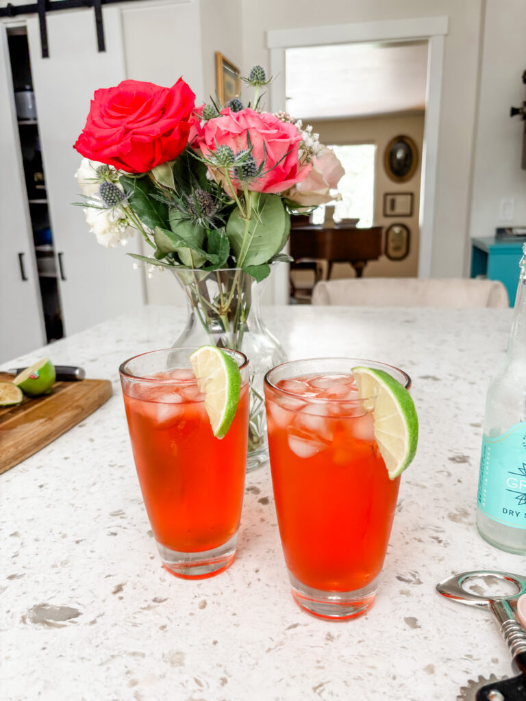 Two of the finished Italian Spritz mocktail garnished with a lime slice