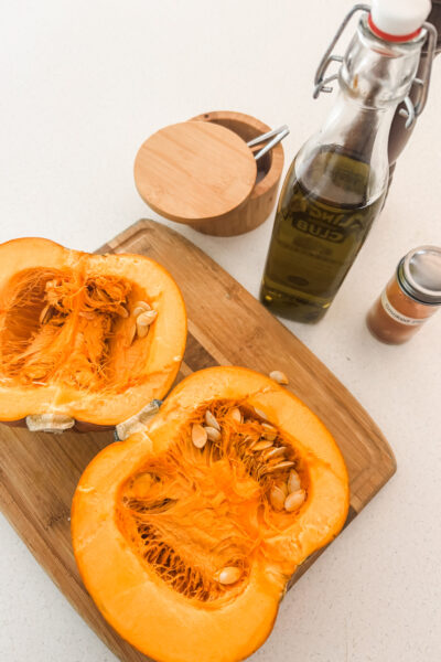 The ingredients for the Oven-Roasted Pumpkin, including the pumpkin cut in half