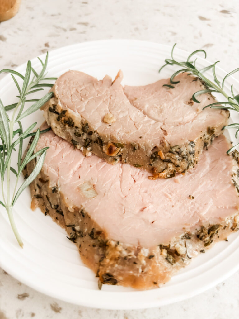Two slices of the Pork Sirloin Roast with springs or rosemary