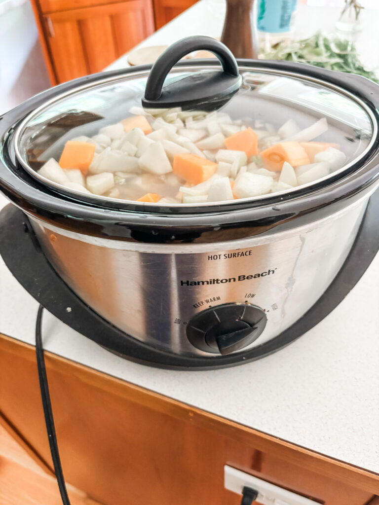 The chopped ingredients in the slow cooker