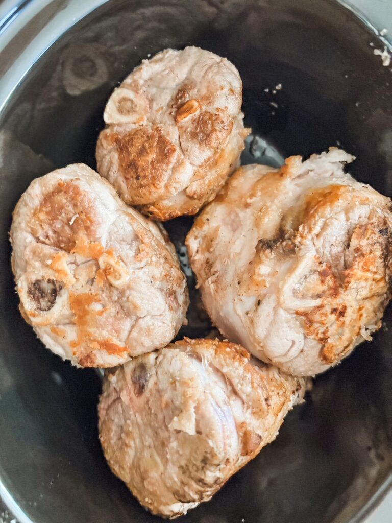 The seared pork shanks now placed in the slow cooker