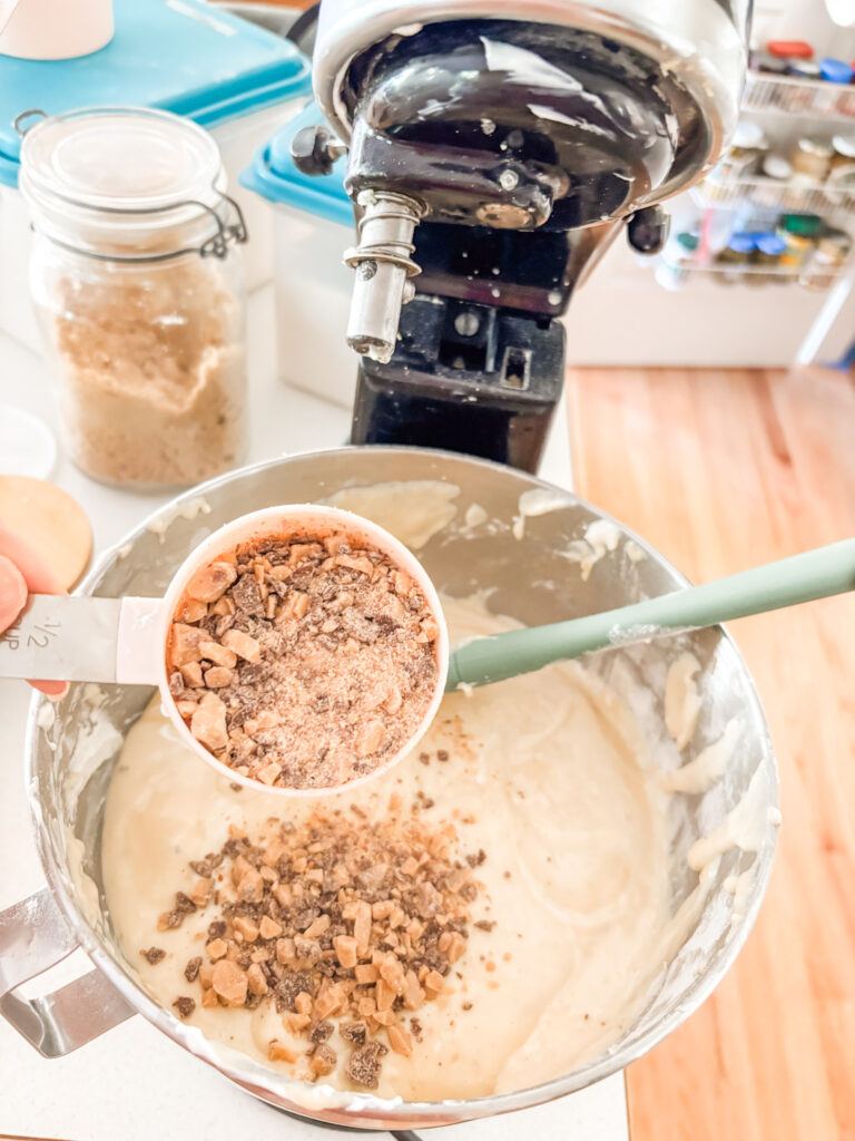 The heath pieces being added into the cake batter