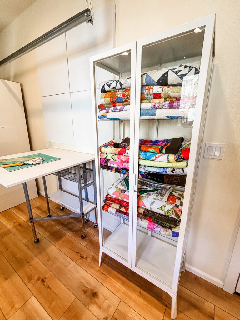 Glass door cabinets with fabrics and quilts