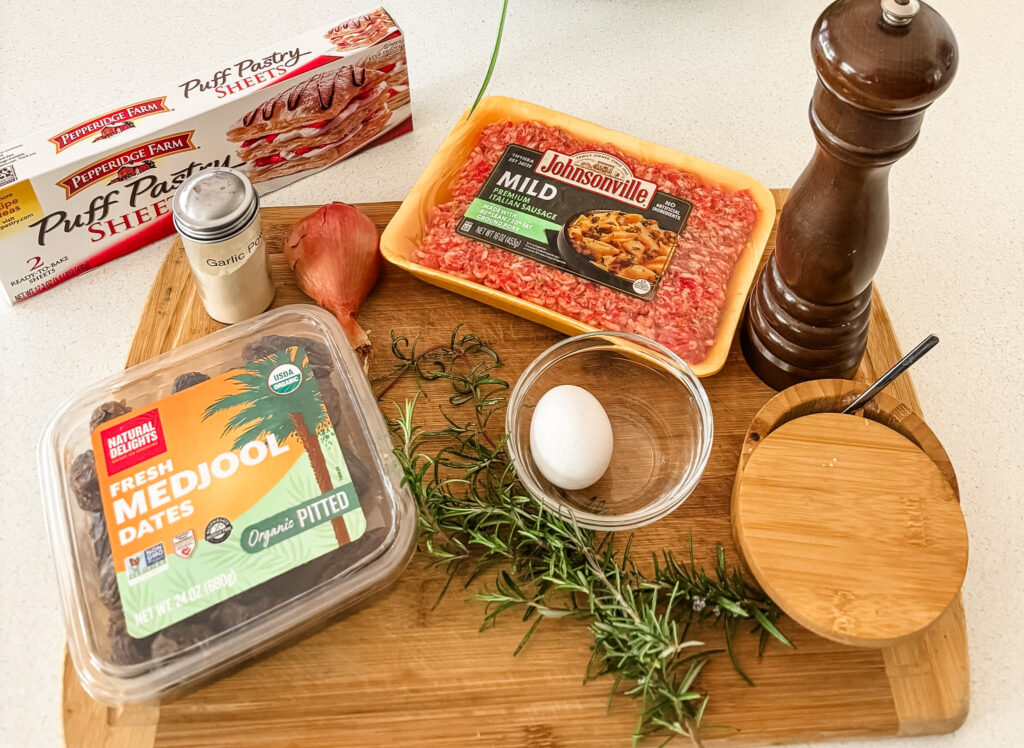 Ingredients for sausage rolls with date and rosemary including Italian bulk sausage, Medjool dates, fresh rosemary, shallots, and puff pastry