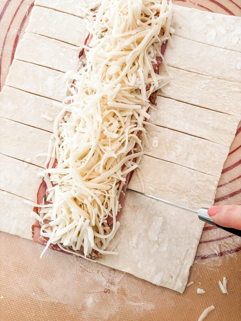 Making perpendicular cuts into the pastry