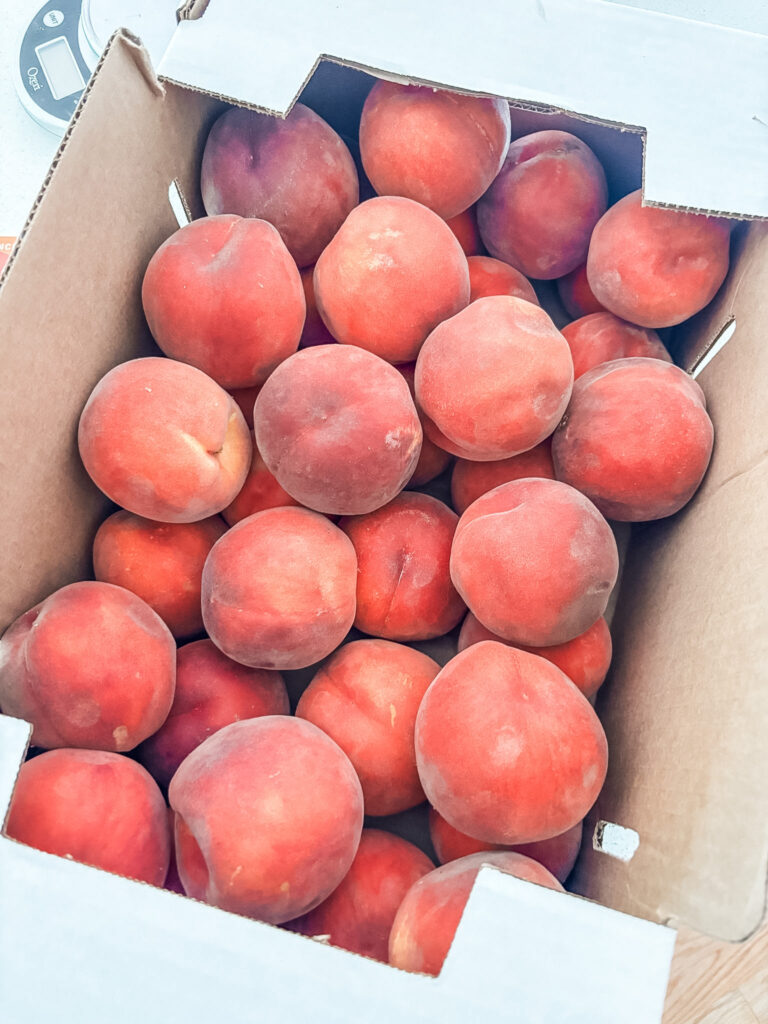 A twenty-five pound box of fresh, ripe Yakima Valley peaches 