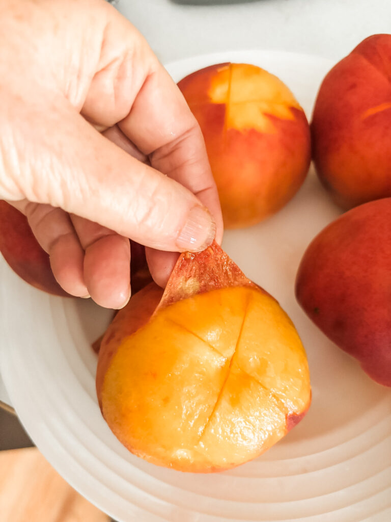 Peach skin sliding off easily by hand after blanching