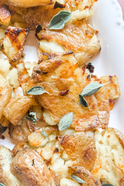 Close-up of a crispy smashed potato showing golden crunchy ridges and a creamy tender center