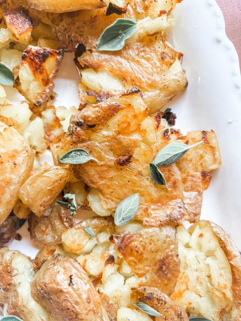 Close-up of a crispy smashed potato showing golden crunchy ridges and a creamy tender center