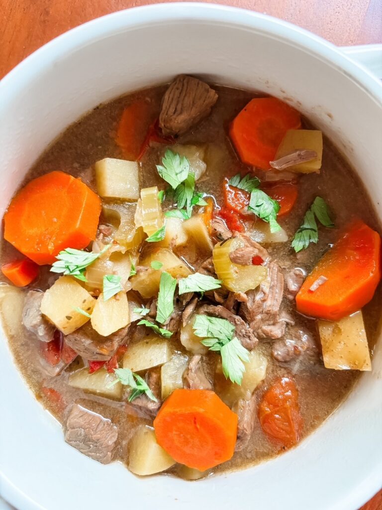 Close-up of healthy beef and beer stew showing tender beef and vegetables in a lightly thickened broth