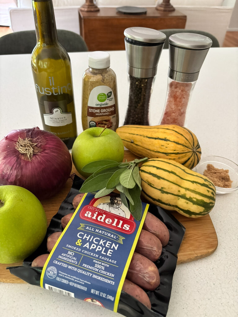 Ingredients for delicata squash sheet pan dinner including delicata squash, chicken apple sausage, red onion, Granny Smith apple, fresh sage, mustard, and brown sugar